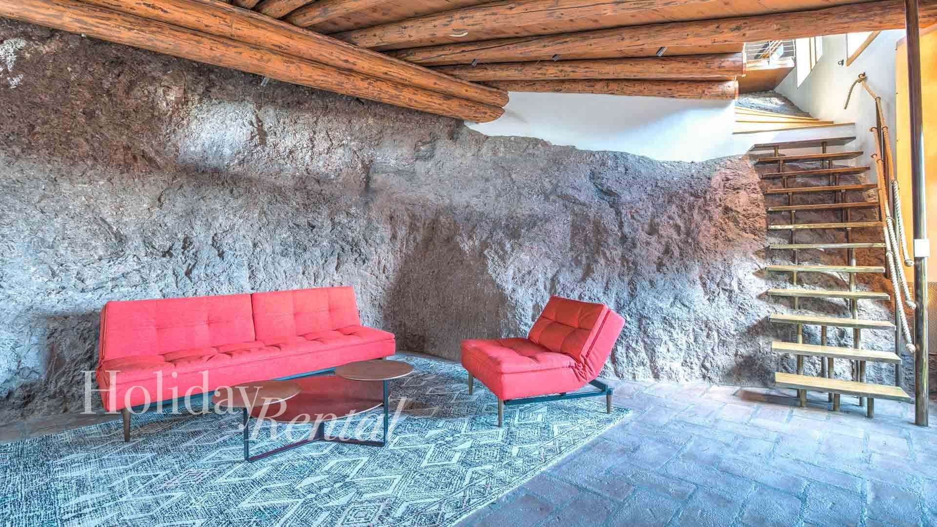 Guest House seating area with stairs leading up to the bedrooms and loft bed